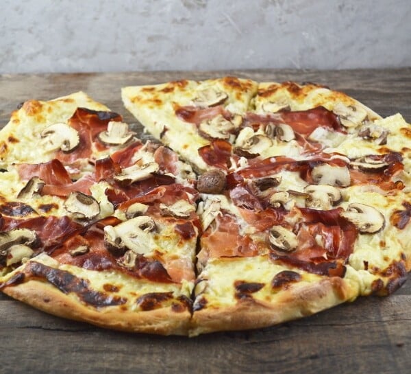 An insanely delicious Cheesy Speck and Mushroom Pizza recipe that is guaranteed to be your new favourite. www.insidetherustickitchen.com