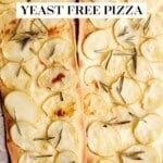 Two potato and rosemary pizzas on a travertine surface.